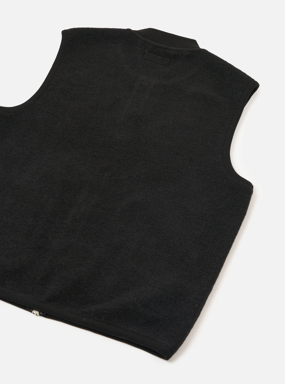 Front view of the Universal Works Black Wool Fleece Zip Waistcoat displayed on a plain white background. The fleece texture, two-way front zipper, ribbed neckline, and two angled lower patch pockets are prominently featured.