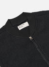Close-up of the Black Wool Fleece Zip Waistcoat, showcasing the texture and zipper detail. Shot against a plain background.