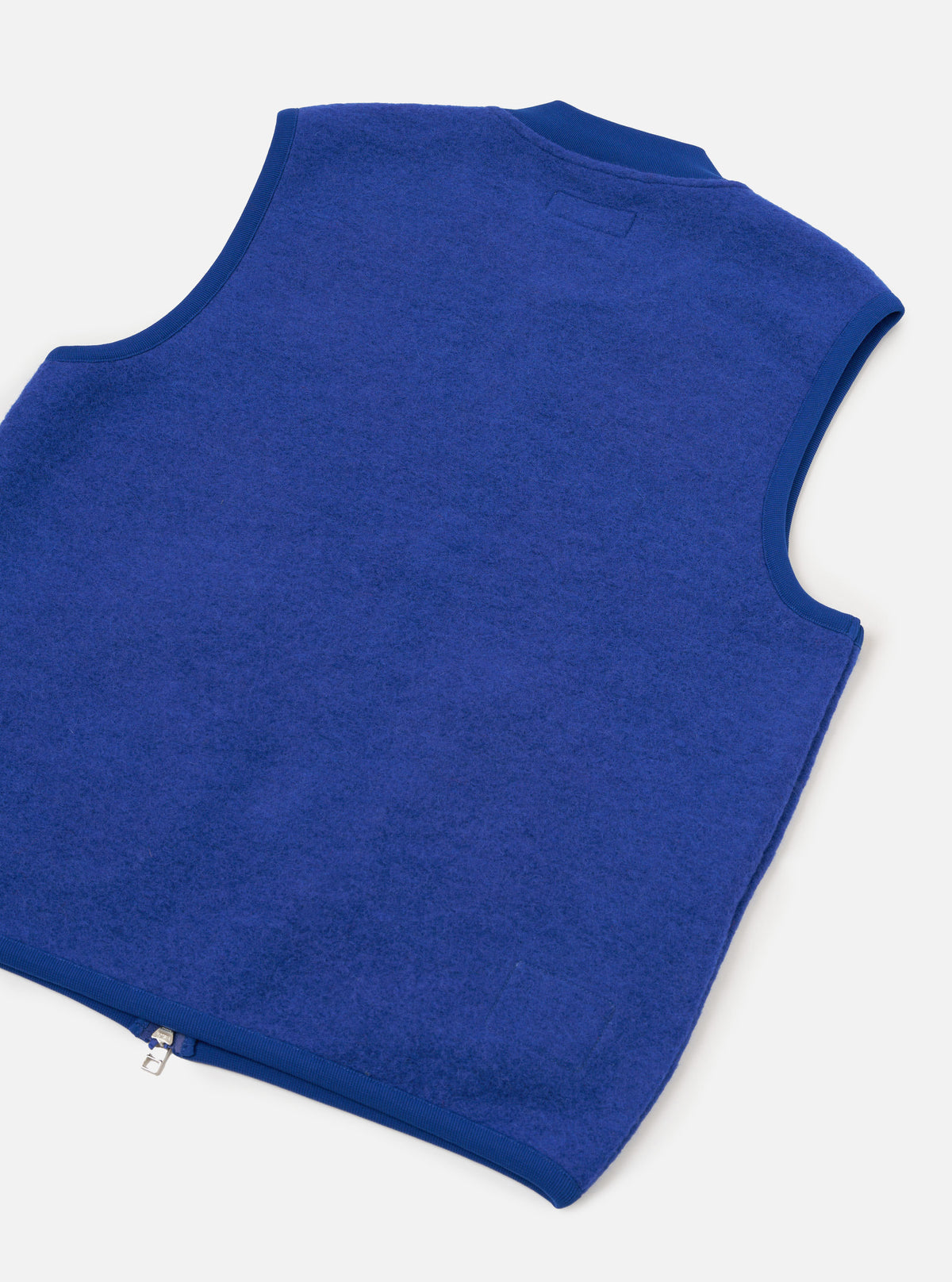 Front view of the Universal Works Blue Wool Fleece Zip Waistcoat displayed on a plain white background. Prominent features include a silver two-way zipper, ribbed neck collar, and two angled front patch pockets.