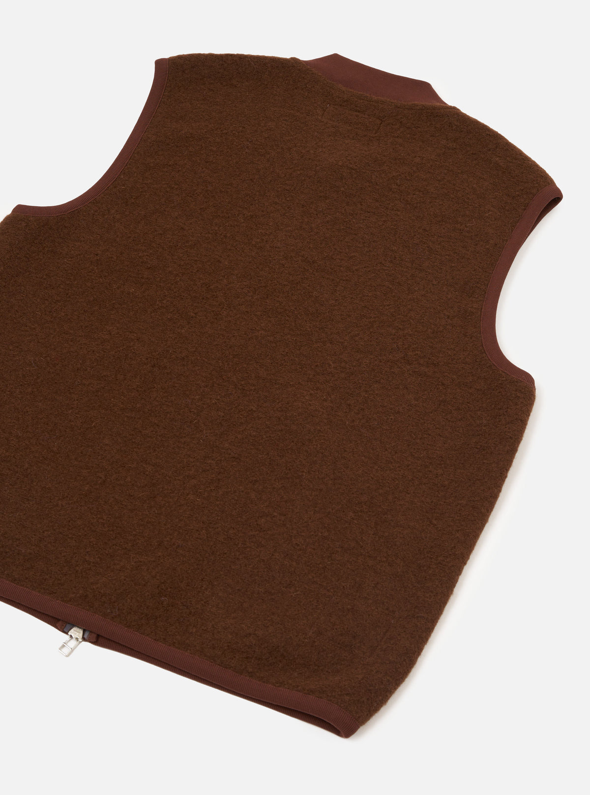 Rear view of the Cacao Wool Fleece Zip Waistcoat presented against a plain white background. The back section highlights the soft cacao brown wool fleece texture, clean hemline, and simple sleeveless construction.