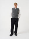 Front view of a model wearing the Grey Marl Wool Fleece Zip Waistcoat layered over a top in a studio setting with a light backdrop. The model stands facing forward, showing how the grey marl fleece waistcoat fits.