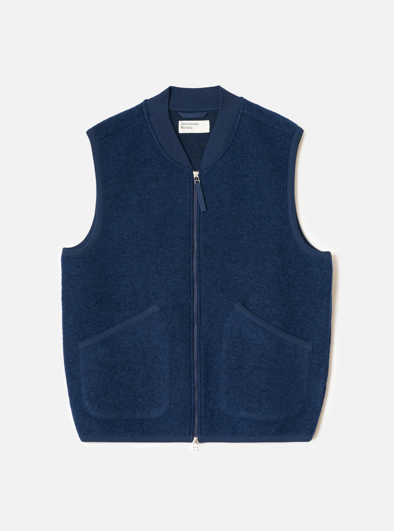 Front view of the Indigo Wool Fleece Zip Waistcoat displayed flat against a plain white background. The deep indigo blue wool fleece fabric, full front zipper, V-neckline, and two lower patch pockets are clearly visible.