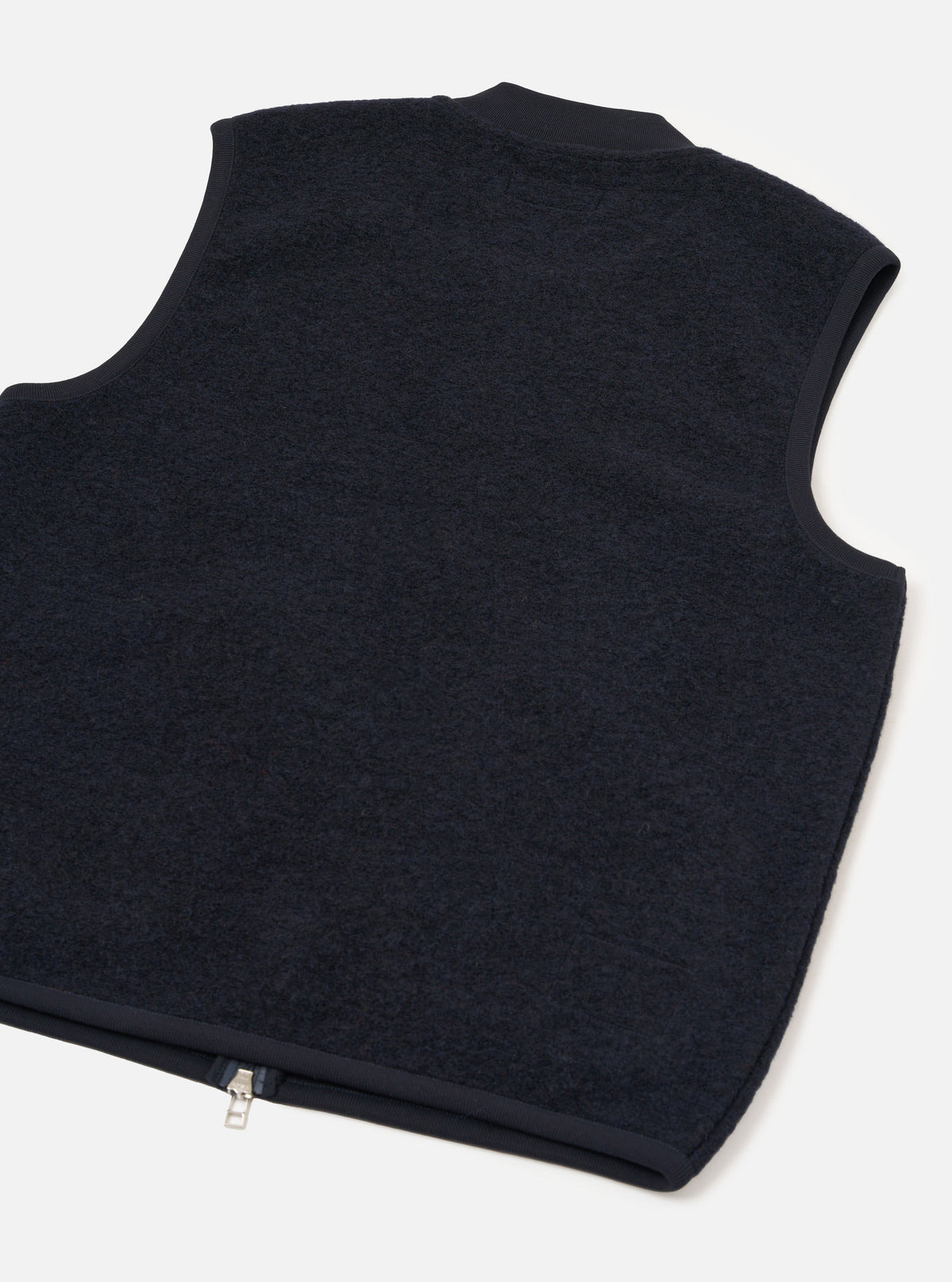 Rear view of the Navy Wool Fleece Zip Waistcoat presented against a plain white background. The back section highlights the soft navy blue wool fleece texture, clean hemline, and simple sleeveless construction.