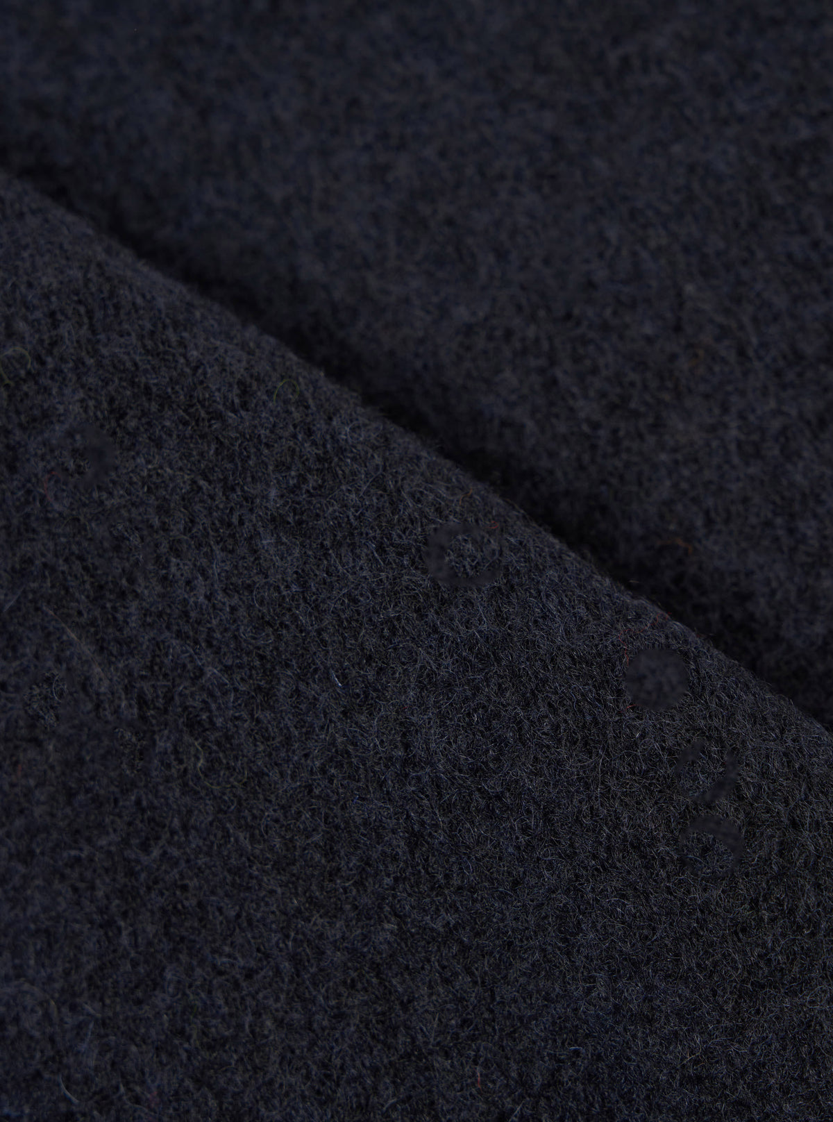 Extreme close-up fabric swatch image showcasing the texture of the Navy Wool Fleece Zip Waistcoat. The detailed shot highlights the rich navy blue tone, soft fibers, and cozy tactile feel of the wool fleece material.