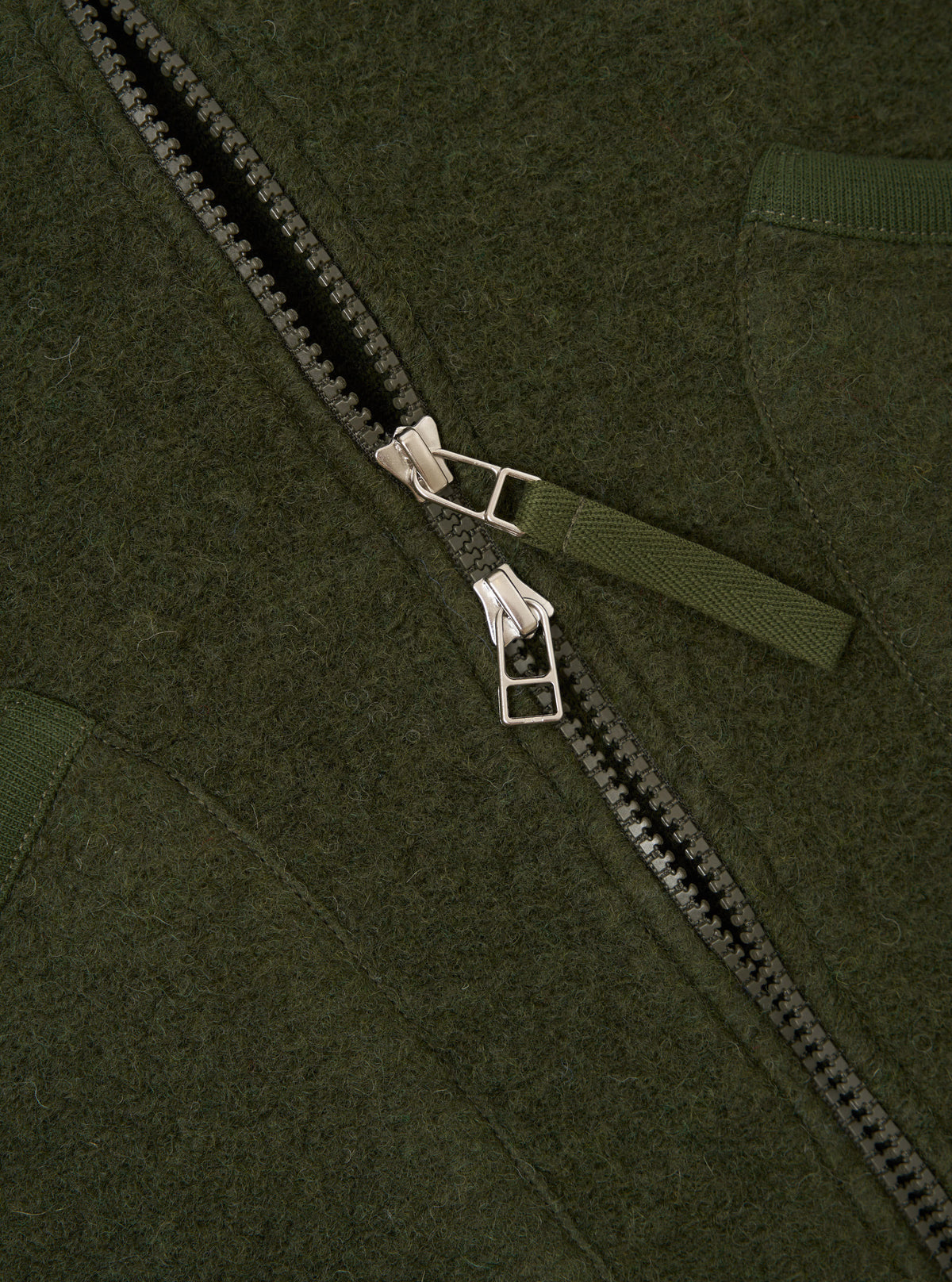 Front view of the Olive Wool Fleece Zip Waistcoat displayed flat against a plain white background. The green textured fleece, full zip front, rounded neckline, and deep angled patch pockets are prominently featured.