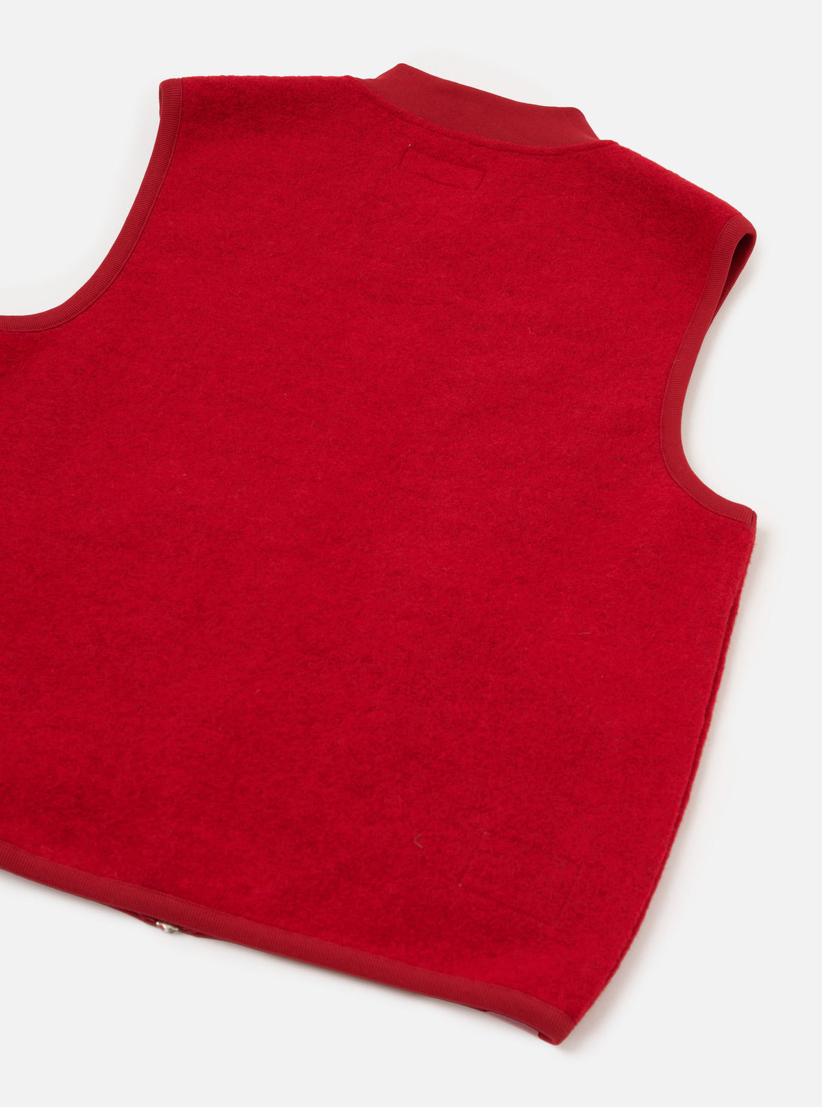 Rear view of the Scarlet Wool Fleece Zip Waistcoat presented against a plain white background. The back section highlights the soft scarlet red wool fleece texture, clean hem, and sleeveless construction.