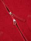 Close-up detail shot of the Scarlet Wool Fleece Zip Waistcoat on a plain background. Focuses on the metallic front zipper hardware, rounded neck trim, and vibrant scarlet red fleece texture of the garment.
