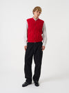 Front view of a model wearing the Scarlet Wool Fleece Zip Waistcoat in a studio setting with a light backdrop. The model stands facing forward, displaying how the red fleece waistcoat fits over clothing.