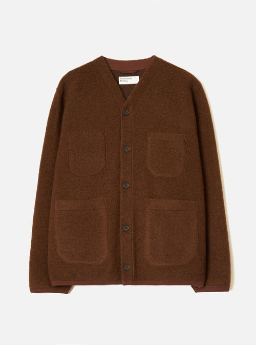 Cacao brown wool fleece cardigan on a plain light grey studio backdrop, no model. V-neckline with a darker brown knit trim visible at collar and cuffs. Five dark buttons down the centre front. Four patch pockets: two chest, two lower. Textured boiled wool fleece fabric throughout. Universal Works woven label at the neck.