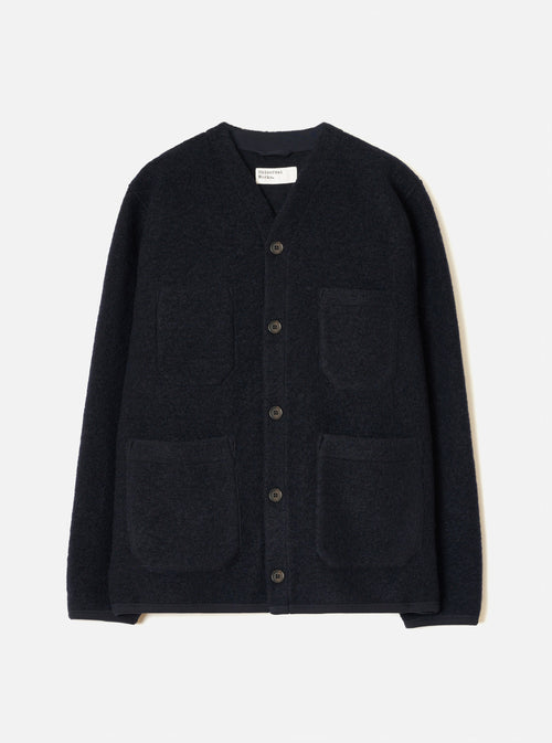 The Navy Wool Fleece Cardigan is laid flat on a light grey studio backdrop. Features include a collarless V-neckline with a woven label, five dark buttons down the front placket, four prominent front patch pockets, and smooth navy bound hems and cuffs.