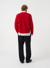 Rear view of a model wearing the Scarlet Wool Fleece Zip Liner Jacket against a plain studio background. The shot highlights the fit across the back, straight hem, and vibrant scarlet red wool fleece material.