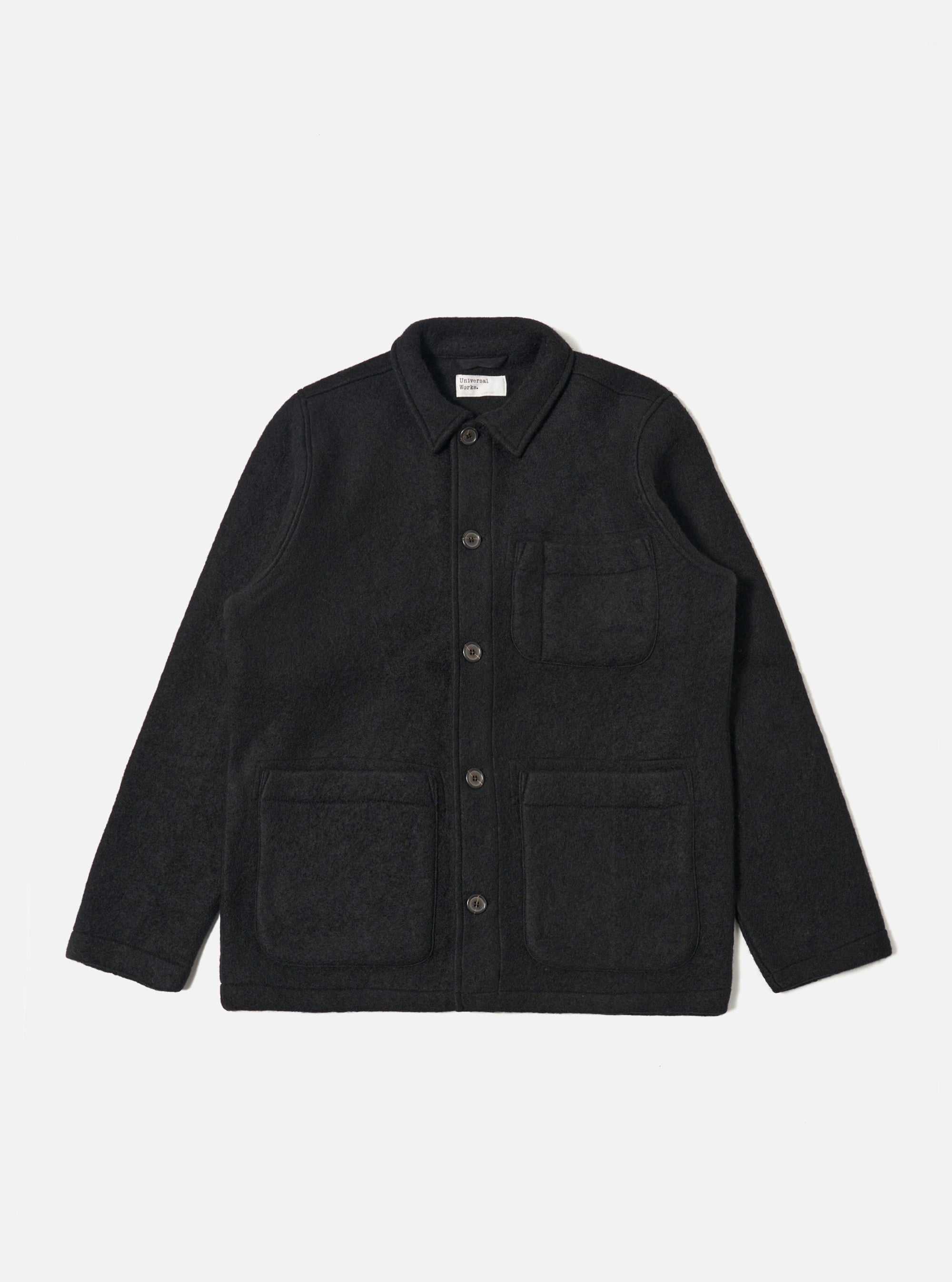 The Black Wool Fleece Field Jacket, made of black wool fleece, is laid flat on a white background. It features a collared neck, button closure, and multiple pockets.
