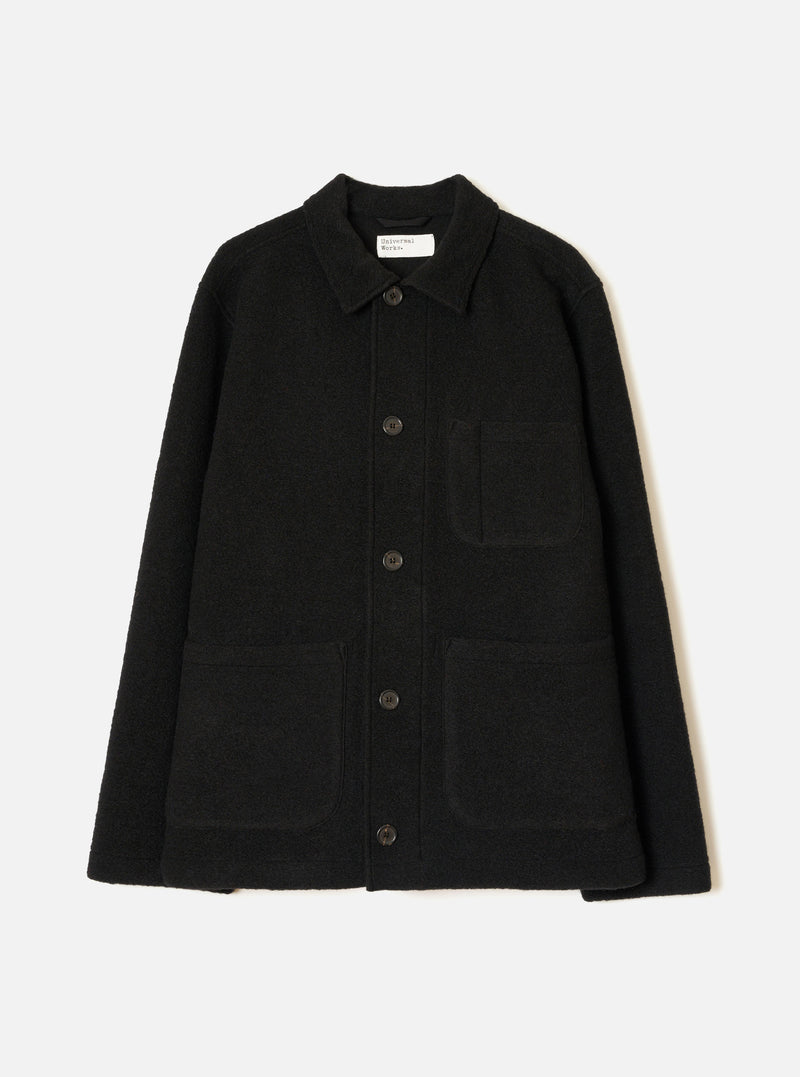 Front view of the Black Wool Fleece Field Jacket displayed flat against a plain white background. Features four front flap pockets, button closure, classic collar, and dark black wool fleece construction.