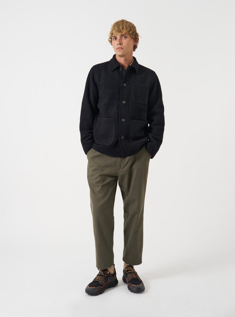 Front view of a model wearing the Black Wool Fleece Field Jacket in a studio setting with a light backdrop. The model stands facing forward, demonstrating how the classic fleece jacket fits.