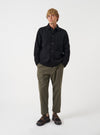 Front view of a model wearing the Black Wool Fleece Field Jacket in a studio setting with a light backdrop. The model stands facing forward, demonstrating how the classic fleece jacket fits.