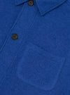 Close-up detail shot of the Blue Wool Fleece Field Jacket on a plain background, focusing on the front flap pocket stitching, button hardware, and soft blue fleece fabric texture.