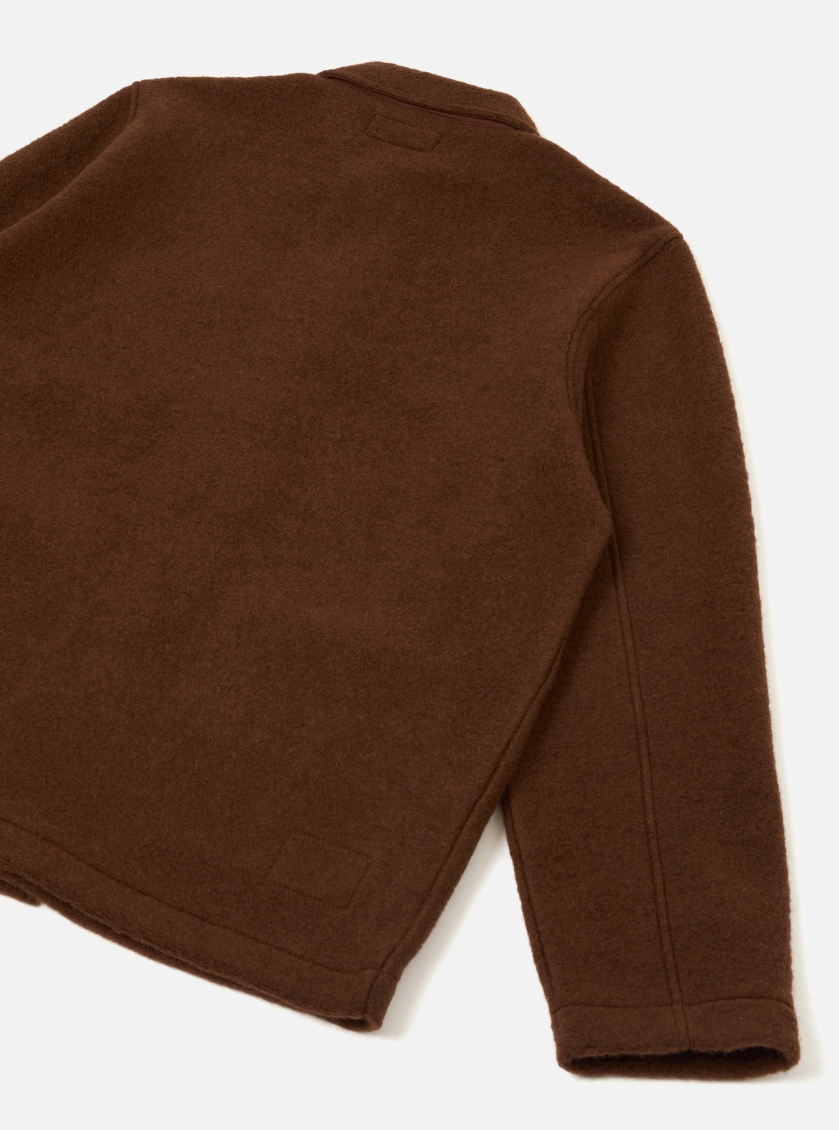Rear view of the Cacao Wool Fleece Field Jacket presented on a plain white background, displaying the back paneling, clean straight hem, and soft cacao brown wool fleece material.