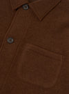 Close-up detail view of the Cacao Wool Fleece Field Jacket on a plain white background, highlighting the button closure, pocket details, and tactile cacao brown wool fleece fabric.
