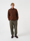 Front view of a model wearing the Cacao Wool Fleece Field Jacket in a studio setting with a light backdrop. The model stands facing forward, displaying the jacket's brown color and fit.