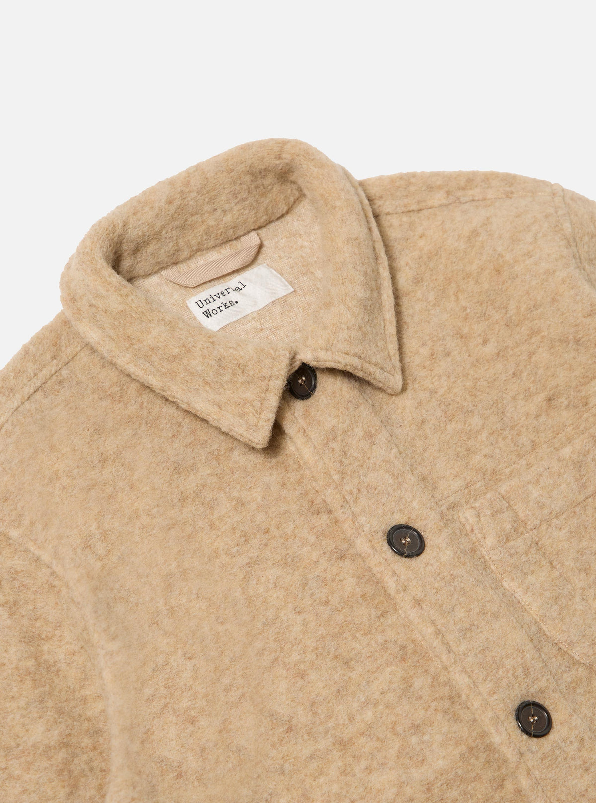 Close-up of the Fawn Wool Fleece Field Jacket on a white background. The jacket is a light tan color and features dark brown buttons.