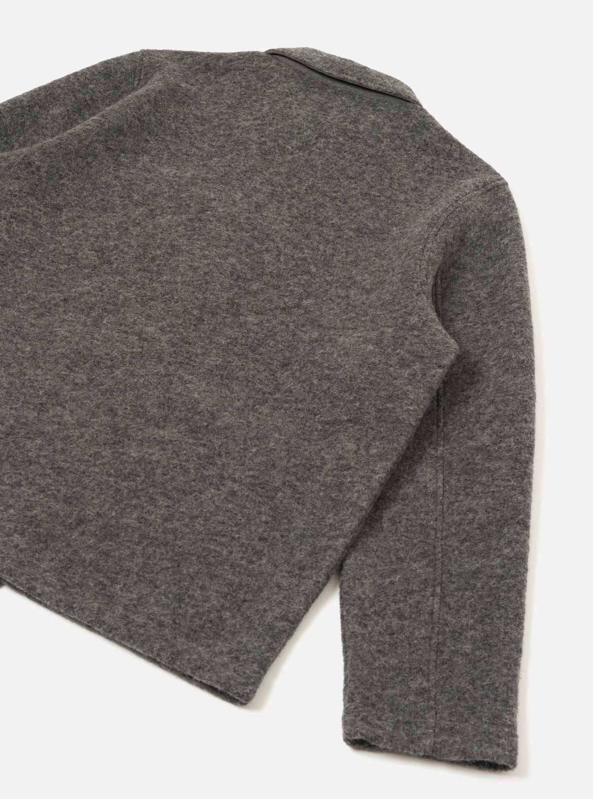 Rear view of the Grey Marl Wool Fleece Field Jacket shown against a solid white background. The clean back construction highlights the textured grey marl wool fleece fabric, classic hem, and long sleeve design.