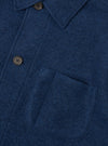 Detailed close-up shot of the Indigo Wool Fleece Field Jacket on a white backdrop. Focuses on the textured wool fleece material, fine stitching, button placket, and flap pocket construction.