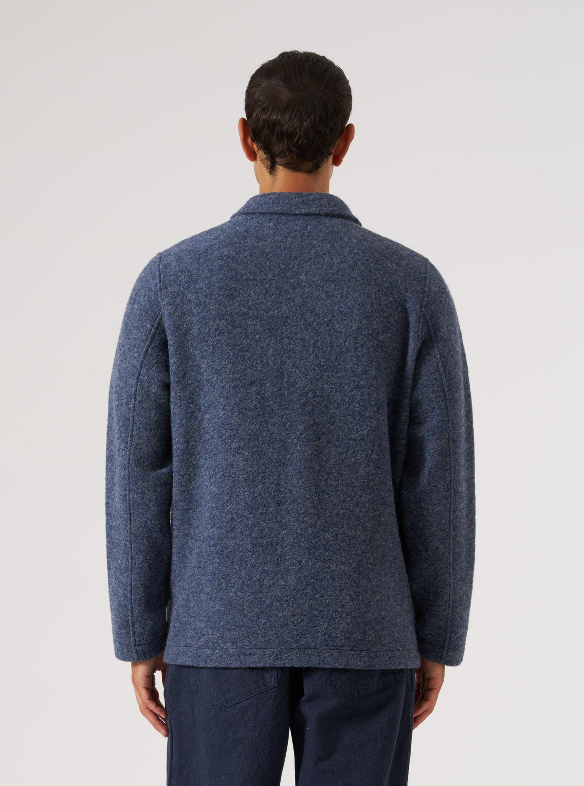 Back view of a model wearing a Slate Blue Wool Fleece Field Jacket. The jacket is wool and the background is a clean white.