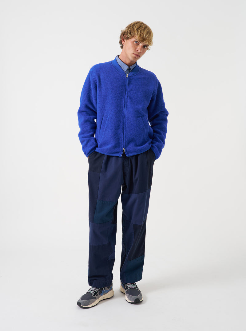 Front view of a model wearing the Blue Wool Fleece Zip Bomber Jacket in a plain studio setting. The model stands facing forward, displaying the rich blue fleece, full front zipper, ribbed collar, and relaxed fit.