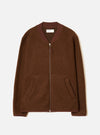 Cacao brown wool fleece zip bomber laid flat on a light grey seamless backdrop. Ribbed bomber collar in a darker burgundy-brown knit trim. Full-length silver zip with a small zip pull. Two open welt hand pockets at the hem. Ribbed cuffs in matching trim. Universal Works woven label visible at the neck.