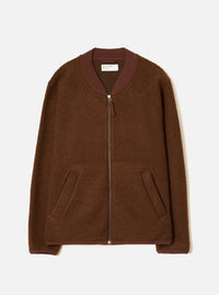 Cacao brown wool fleece zip bomber laid flat on a light grey seamless backdrop. Ribbed bomber collar in a darker burgundy-brown knit trim. Full-length silver zip with a small zip pull. Two open welt hand pockets at the hem. Ribbed cuffs in matching trim. Universal Works woven label visible at the neck.