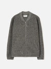 Grey marl wool fleece zip bomber, flat lay on a light grey seamless backdrop. Ribbed bomber collar with a centre-front silver zip and leather zip pull. Two welt hand pockets at the hem. Ribbed cuffs and hem band. Textured boiled wool fleece fabric throughout. Universal Works label visible at the inner collar.