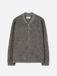Grey marl wool fleece zip bomber, flat lay on a light grey seamless backdrop. Ribbed bomber collar with a centre-front silver zip and leather zip pull. Two welt hand pockets at the hem. Ribbed cuffs and hem band. Textured boiled wool fleece fabric throughout. Universal Works label visible at the inner collar.