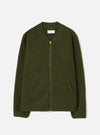 Olive wool fleece zip bomber, flat lay on a light grey seamless backdrop. Features a ribbed bomber collar, full-length silver zip with a fabric puller, and two welt hand pockets at the hem. The textured boiled wool fleece body contrasts with smoother ribbed cuffs and hem. A Universal Works woven label is visible at the neck.