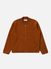 The Rust Wool Fleece Zip Bomber jacket in rust color, laid flat on a white background. The bomber has a zip front and pockets.