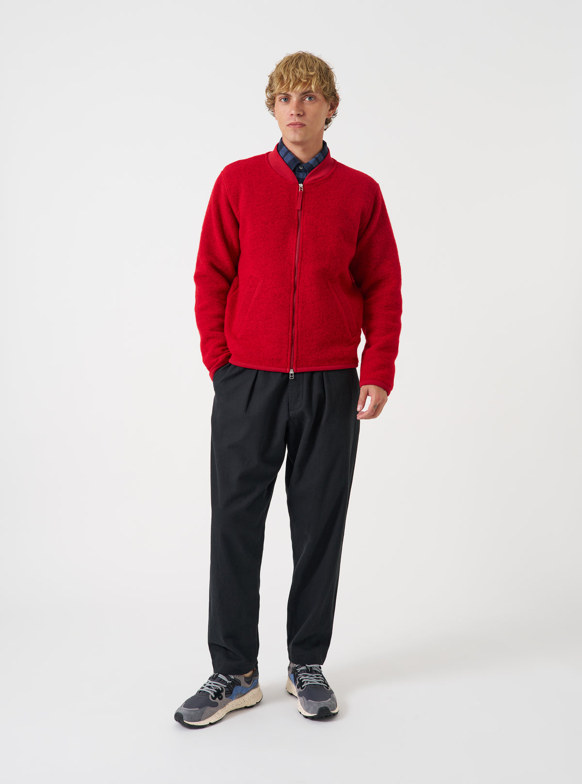 Front view of a model wearing the Scarlet Wool Fleece Zip Bomber Jacket against a studio background. The model faces forward, highlighting the bright red wool fleece fabric, full front zipper, collar, and rib cuffs.