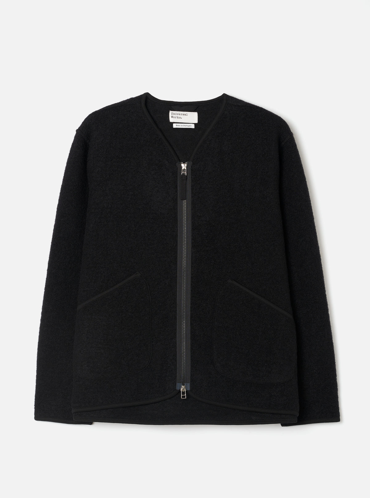 Front view of the Black Wool Fleece Zip Liner Jacket displayed flat against a plain white background. The deep black wool fleece fabric, full-length front zipper, collarless neck, and patch pockets are clearly highlighted.