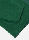 Close-up of the green Wool Fleece Zip Liner Jacket on a white surface. The jacket is made of green wool fleece with a zip. The image shows the texture and details of the jacket.