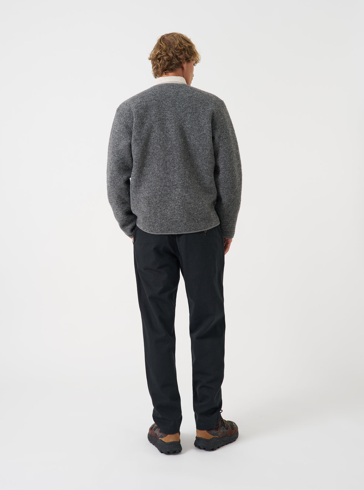 Back view of a model wearing the Grey Marl Wool Fleece Zip Liner Jacket against a neutral background. Highlights the fit across the shoulders and back, detailing the heathered grey wool fleece texture.