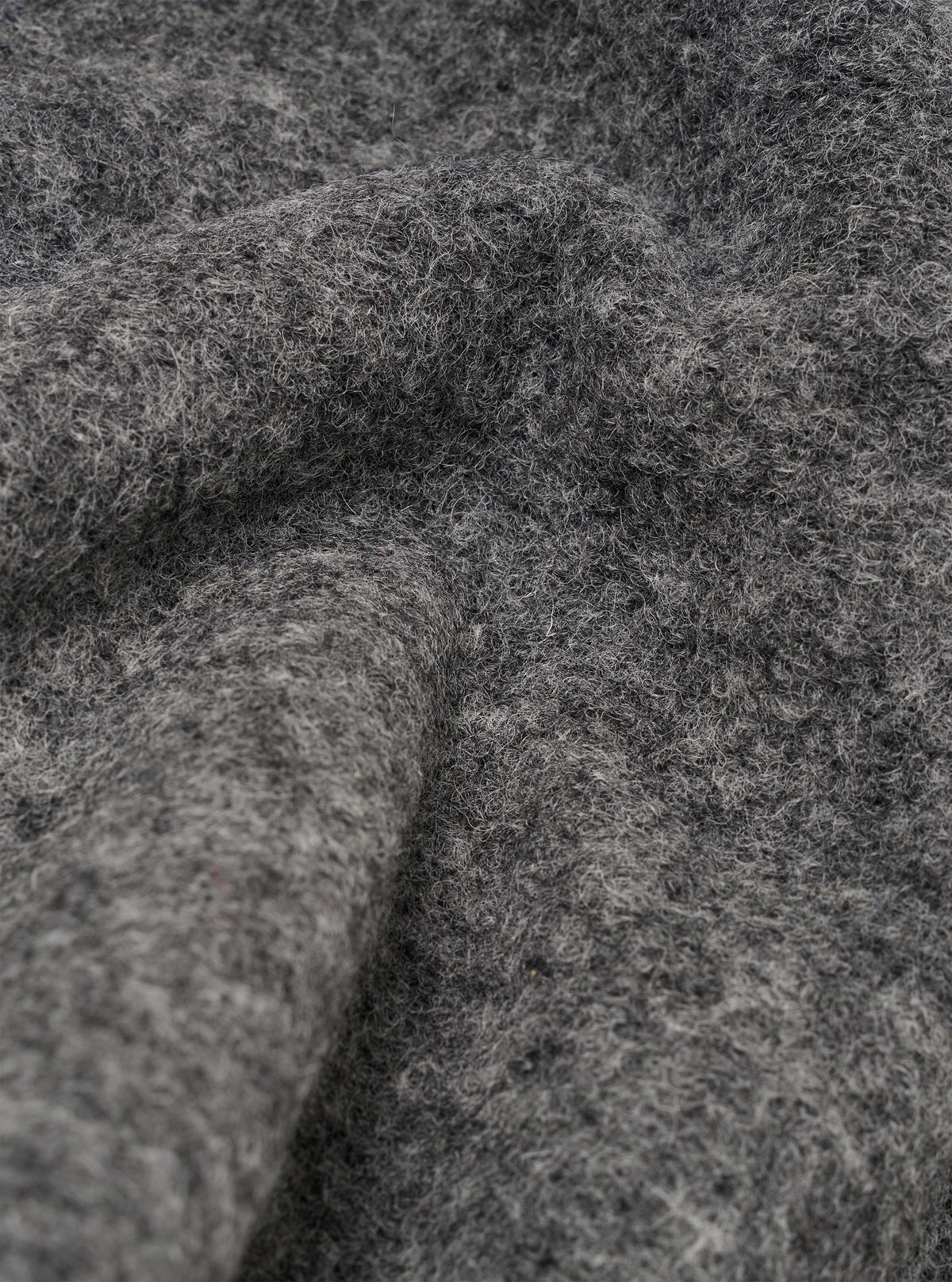 Close-up detail shot of the grey marl wool fleece fabric used in the zip liner jacket. The texture is thick, fluffy and heavily brushed with visible loose fibres throughout. The fabric is folded and draped, showing depth and volume in the pile against a neutral background.