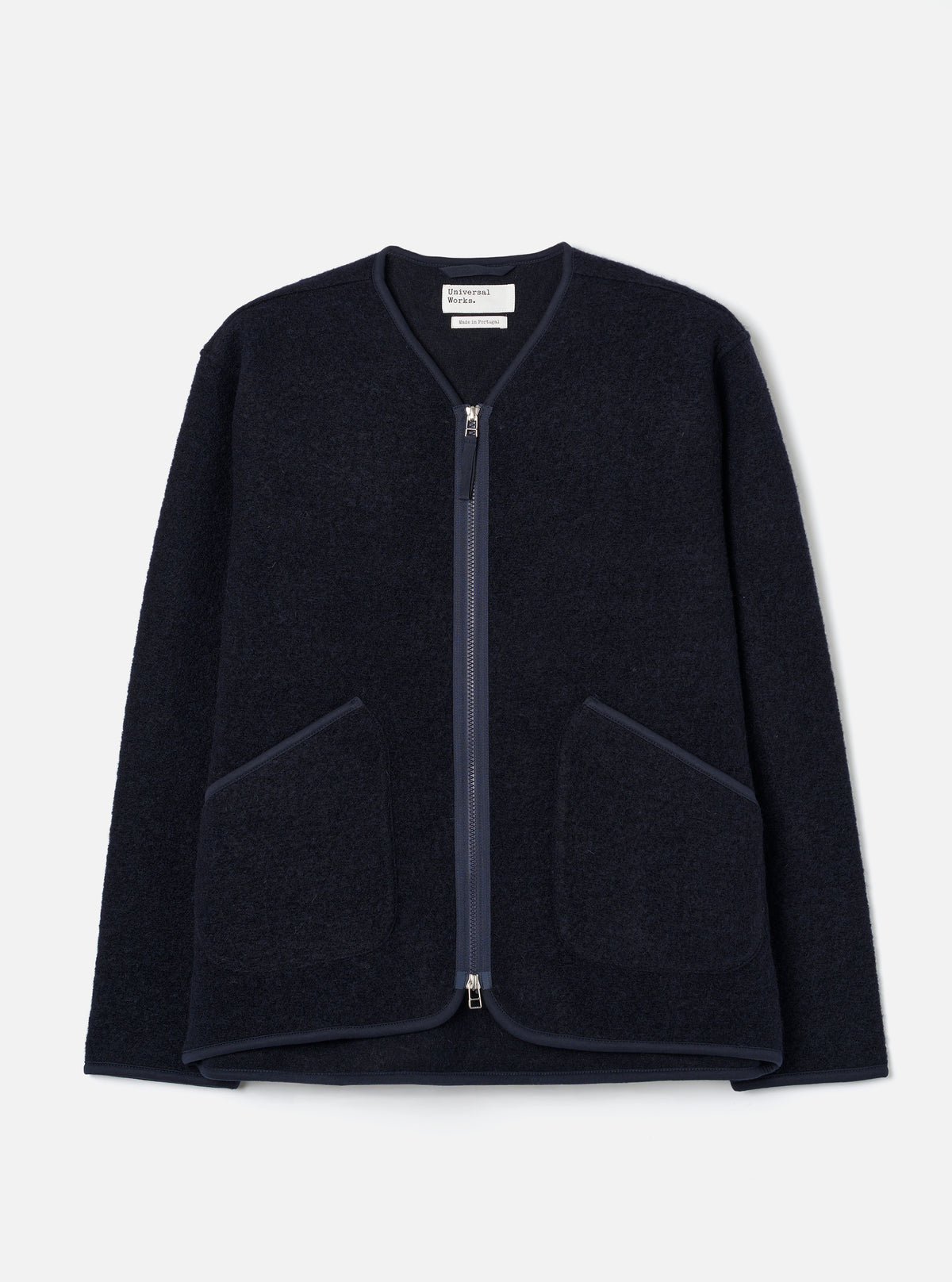 Front view of the Navy Wool Fleece Zip Liner Jacket displayed flat against a plain white background. The deep navy blue wool fleece fabric, full front zipper, collarless design, and lower pockets are featured.