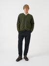 Front view of a model wearing the Olive Wool Fleece Zip Liner Jacket standing in a minimal studio setting with a neutral backdrop. The model showcases the front zipper, comfortable fit, and olive fleece material in natural light.