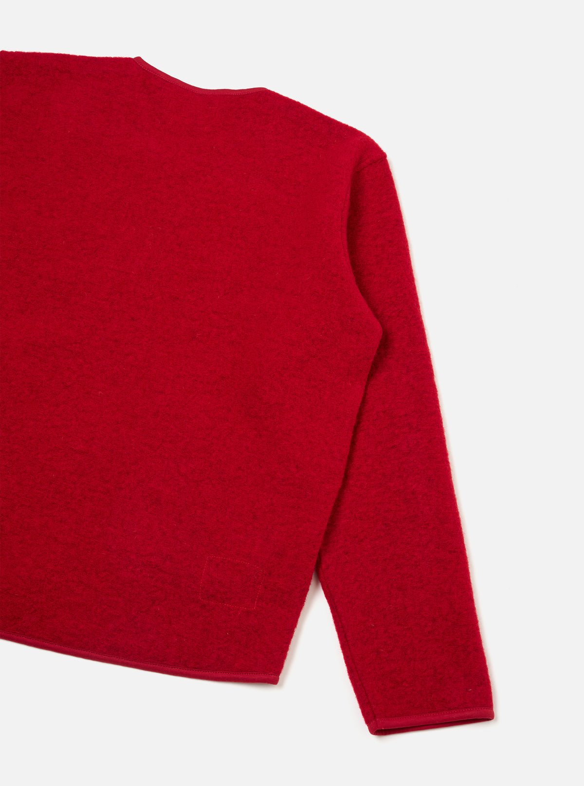 Back view of the Scarlet Wool Fleece Zip Liner Jacket displayed against a plain off-white background. Showcases the clean rear silhouette, soft scarlet red fleece texture, and precise edge finishing along the hemline.