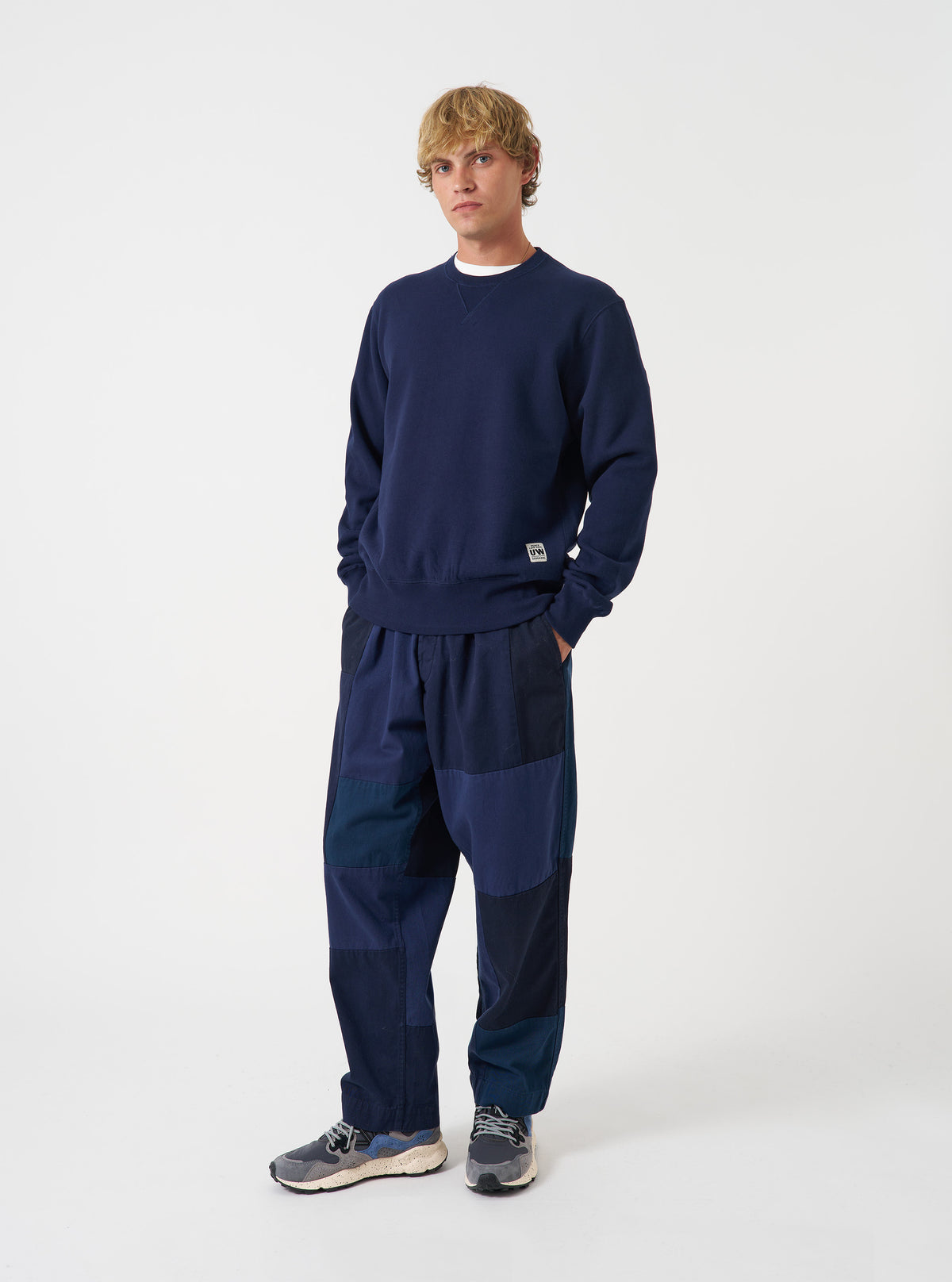 Front view of a model wearing the Navy Brush Back Sweat Core Sweatshirt against a plain studio background. The model stands facing forward, showing the crew neckline, ribbed cuffs, hem, and relaxed fit.