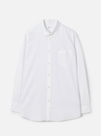 Front view of the White Oxford Daybrook Shirt displayed flat against a plain white background. Highlights the button-down collar, single chest pocket, long sleeves, and crisp white organic cotton oxford fabric construction.