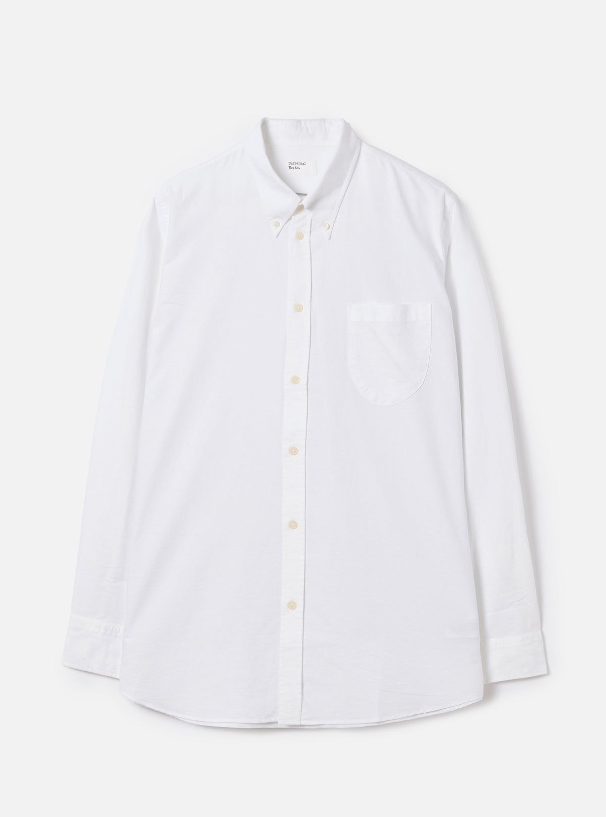 Front view of the White Oxford Daybrook Shirt displayed flat against a plain white background. Highlights the button-down collar, single chest pocket, long sleeves, and crisp white organic cotton oxford fabric construction.
