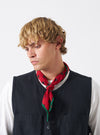 A model wearing the Red/Black Bold Dot Print Rayon Scout Scarf styled around the neck in a studio setting. Highlights the bold red fabric and black dot print pattern against a plain studio background.