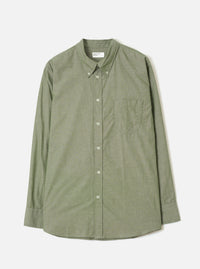 Front view of the Olive Prince Chambray Daybrook Shirt laid flat on a light grey backdrop. Features a spread collar, button-front placket, a single patch pocket on the left chest, and long sleeves with buttoned cuffs. No model or mannequin present.