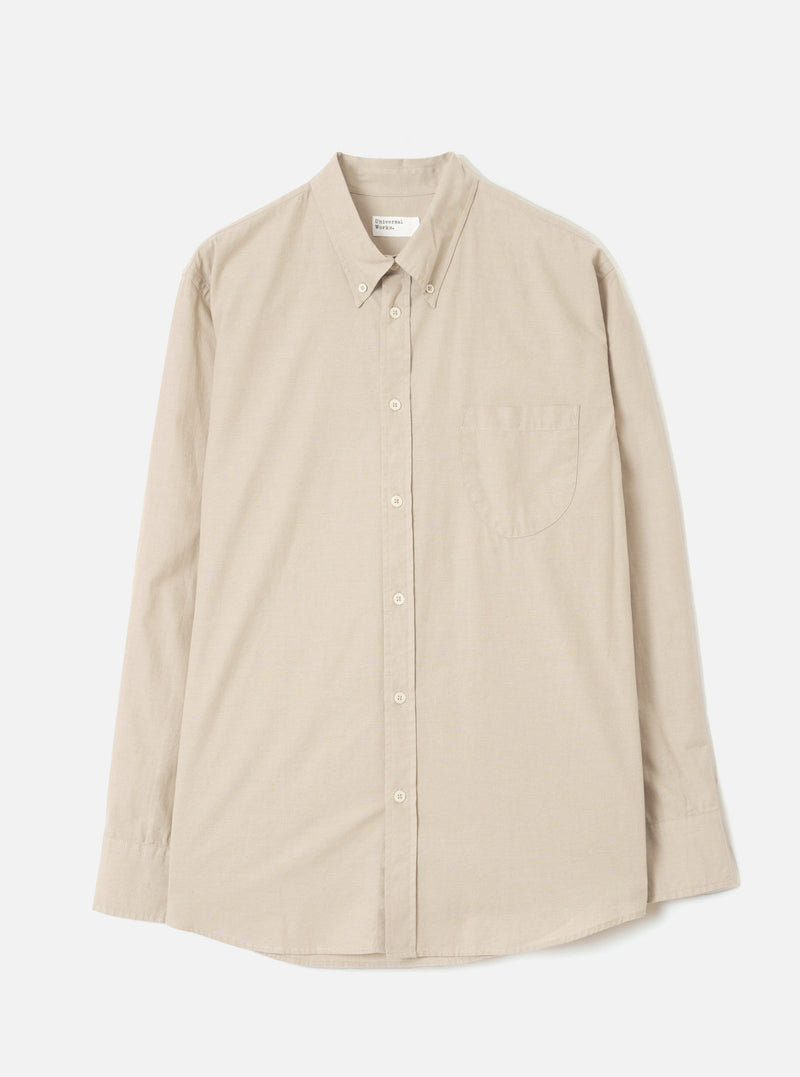 Front view of the Sand Prince Chambray Daybrook Shirt laid flat on a plain light grey studio backdrop. Prominent features include a pointed collar, a full-length button placket, a single chest patch pocket, and long sleeves with button cuffs.