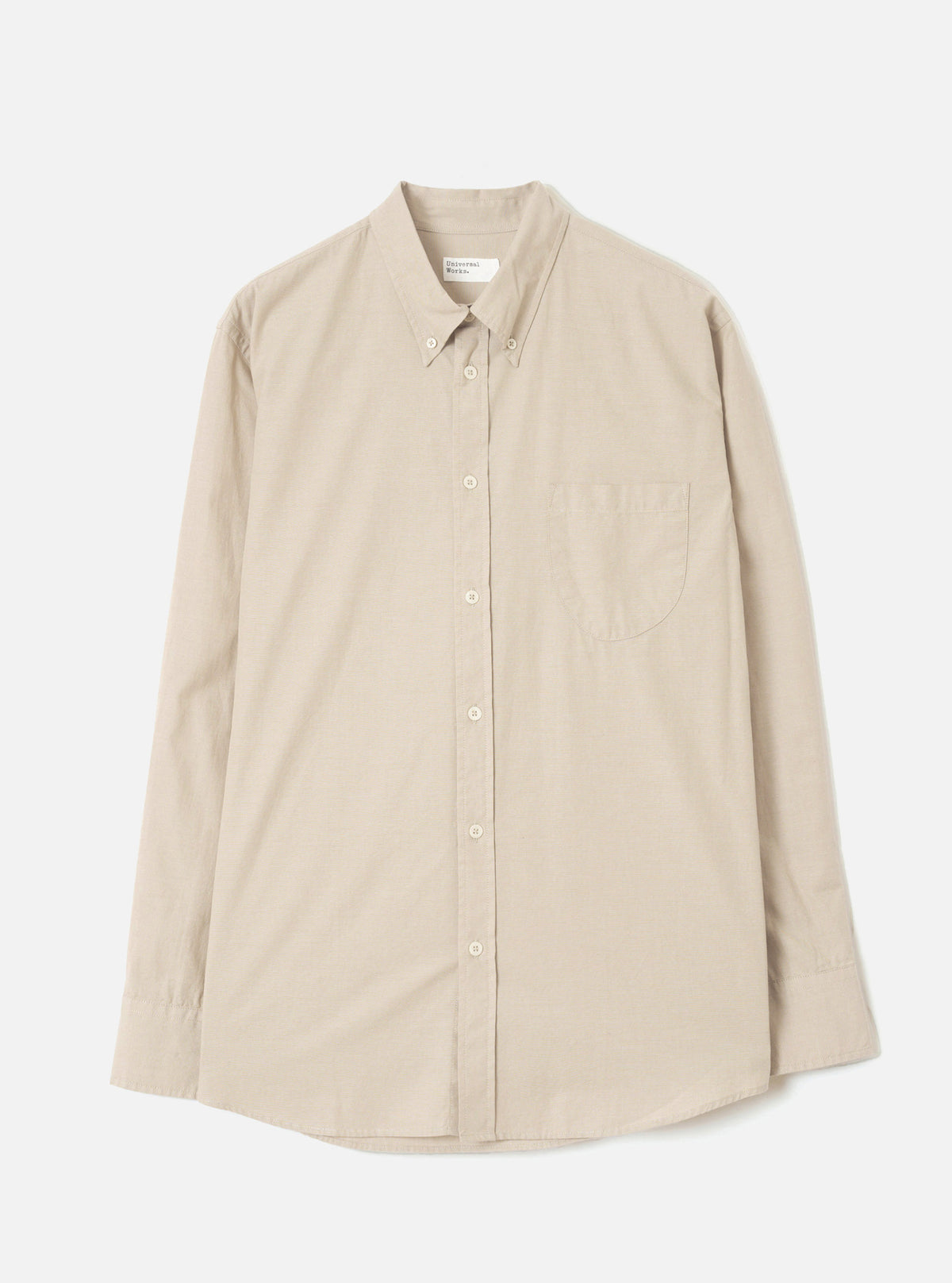 Front view of the Sand Prince Chambray Daybrook Shirt laid flat on a plain light grey studio backdrop. Prominent features include a pointed collar, a full-length button placket, a single chest patch pocket, and long sleeves with button cuffs.
