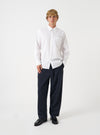 Front view of a model wearing the White Prince Chambray Daybrook Shirt in a studio setting with a light backdrop. The model stands facing forward, showing the classic fit, neat collar, chest pocket, and full buttoned placket.